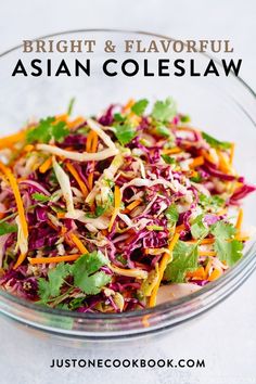 a glass bowl filled with coleslaw and garnished with cilantro