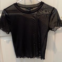 Black See-Through Tee. Never Worn. Cute Edge Detail To Arms And Bottom Of Top. Size M Trendy Black Mesh Crop Top, Casual Mesh Crop Top For Night Out, Sheer Short Sleeve Crop Top For Night Out, Black Sheer Short Sleeve T-shirt, Casual Sheer Tops For Night Out, Edgy Summer T-shirt For Night Out, Trendy Short Sleeve Mesh Top For Night Out, Forever 21 Stretch Crew Neck Top, Trendy Black Crew Neck Mesh Top