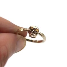 Absolutely gorgeous realistic memento mori skull gothic ring in all 14k solid gold. Extremely detailed design of the skull, hammered band for a rustic feel yet with tiny facets all over for a glossy silver shimmer. This minimalist cool and tough look ring is light and comfortable to wear and will be great for everyday use, as for a special occasion. Great choice as a gift to yourself or someone who can look this skull in the eyes. Features: * One solid 14k gold ring. * Skull is approximately: 10 Gothic Gold Skull Ring For Halloween, Gold Gothic Skull Ring For Halloween, Gothic Skull Ring For Formal Occasions, Formal Gothic Skull Ring, Halloween Skull Promise Ring, Engraved Skull Ring For Anniversary, Engagement Ring Gothic, Memento Mori Ring, Surf Necklace