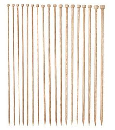 wooden knitting needles are lined up on a white background