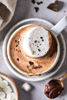 a cup of hot chocolate with marshmallows on the side