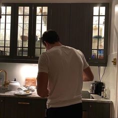 a man standing in the kitchen preparing food