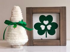 a st patrick's day decoration next to a frame with a shamrock on it