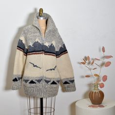 Incredible vintage find. Iconic hand knit Canadian Cowichan wool sweater jacket by Randall Cosco. Muted soft pallet with a graphic mountain and birds landscape pattern across the front and back. Heavy weight for fall/winter. Front heavy duty zip and side pockets. Rare find. In good condition with some normal fuzzy/pilling here and there, not a big deal at all.  BUST: 42" WAIST: 40" HIP: 38" LENGTH: 30" Birds Landscape, Graphic Mountain, Cowichan Sweater, Landscape Pattern, Big Deal, Wool Sweater, Jacket Coat, Wool Sweaters, Heavy Weight