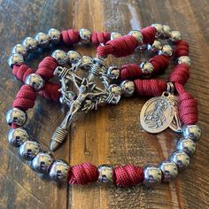 Presenting this handcrafted Precious Blood Chaplet, meticulously made in the U.S.A. with top-quality materials to withstand the test of time. The durable paracord and stainless steel beads ensure longevity, making it a beautiful and enduring symbol of our faith. We make these chaplets with:       * 55O Military Spec Red Paracord       * 2.25 inch Crown and Nails Crucifix       * 1-inch Sacred Heart Medal       * 1-inch Miraculous Medal       * 10mm 304 Stainless Steel Beads       * Stainless Ste Rugged Rosary, Paracord Rosary, December 2nd, Blood Of Christ, Paracord Beads, Thanksgiving Break, Monday December, Catholic Rosary, Split Rings