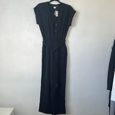 Black Button Down Jumpsuit, Waist Tie, Elastic Waistband Black Button-up Jumpsuit For Work, Black Button-up Jumpsuits And Rompers, Black Button-up Jumpsuits And Rompers For Summer, Elegant Solid Color Button-up Jumpsuit, Black Fitted Button-up Jumpsuits And Rompers, Black Jumpsuits And Rompers With Button Closure For Spring, Black Summer Jumpsuit With Button Closure, Chic Black Jumpsuits And Rompers With Buttons, Black Overalls And Rompers With Buttons