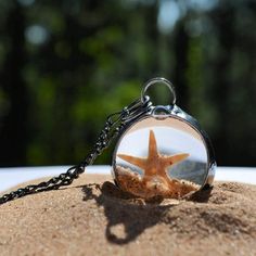 Round pendant with starfish, shells and sand encased in glass creating a shaker necklace. Made in USA Star-shaped Resin Jewelry For Gifts, Star Shaped Resin Jewelry Gift, Ocean-inspired Glass Necklaces For Gifts, Moving Jewelry, Sand Jewelry, Best Teacher Gifts, Teacher Mom, Moon Pendant Necklace, Figaro Chains