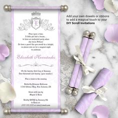 a purple and white wedding card with flowers on the side, next to two candles