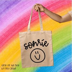 Smile sonrie- Tote bag- Spanish teacher gift - Teacher bag - 100% Cotton canvas bag- Maestra de español Readers bag 100% Cotton canvas.  LENGTH  16.0  WIDTH  15.0  Perfect for school. ++Take a look at my earrings: https://www.etsy.com/shop/TapasforTwoGifts?ref=seller-platform-mcnav&section_id=24390407 ++ Are you a Spanish teacher? You will love these: https://www.etsy.com/shop/TapasforTwoGifts?ref=l2-shopheader-name&section_id=24193028 ++ Tote Bags https://www.etsy.com/shop/TapasforTwoGifts?ref=seller-platform-mcnav&section_id=24205509 ++T-shirts https://www.etsy.com/shop/TapasforTwoGifts?ref=seller-platform-mcnav&section_id=24313083 ~WASH & CARE~ For best results, machine wash cold inside out with mild detergent and hang dry.  ~RETURN POLICY~ We are confident that this product will satisf Back To School Gift Canvas Tote Bag, Cricut Bags Canvas Totes Kids, Cheap White Canvas Bag For Teacher Appreciation, Teacher Canvas Bag, Spanish Teacher Gifts, Handpainted Tote Bags, Eco-friendly Rectangular Canvas Bag With Graphic Print, Cricut Explore Projects, Teacher Bags