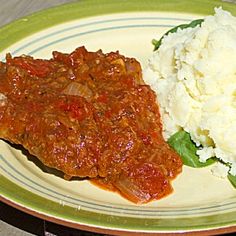 a plate with meat and mashed potatoes on it