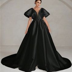 This Polished Princess Gown Features A Carefully Plunge Bodice With An Enormous, Sleeve Detail And Wavy Skirt Of Glamorous Volume. Dramatic Black Party Dress, Dramatic Black Formal Evening Dress, V-neck Gala Gown, Black Evening Dress With Sweep Train For Night Out, Black Gown With Sweep Train For Night Out, Dramatic Black Dress For Gala, Evening Dresses With Long Train For Prom Season, Long Train Dresses For Evening Prom Season, Long Train Dress For Prom Evening