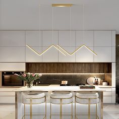 a modern kitchen with white and gold accents