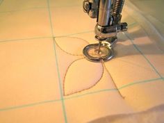 the sewing machine is working on the piece of fabric that has been stitched together