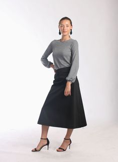 "Be right on clean minimal look with Aline midi skirt in timeless simplicity Black cotton skirt sits a little high on waist making your silhouette long and lean Midi length is super chic for this season Pair with simple top and heels or knee high boots to keep style minimal and polished Or wear as a chic casual skirt paired with snickers or athletic shoes -Tailored fit -Waist sits around naval -Side hidden zipper -Made of soft feel medium weighted cotton fabric with hint of stretch -Finishing is Lined Pencil Dress With Relaxed Skirt, Relaxed Midi Pencil Skirt With Lining, Full Skirt With Relaxed Fit And Lining, Long Relaxed Lined Skirt, Stretch Flared Lined Skirt, Stretch Flared Skirt With Lining, Stretch Midi Skirt With Gathered Details, Stretch Lined Flared Skirt, Relaxed Fit Lined Midi Skirt