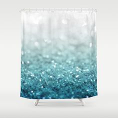 a shower curtain with blue and green glitter