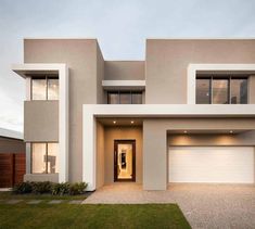 a modern house with two garages in the front and one on the other side