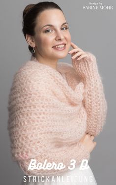 a woman wearing a pink sweater and white dress