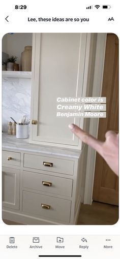 a kitchen with white cabinets and marble counter tops in the background is an advertisement for cabinet color is creamy white belphan moore