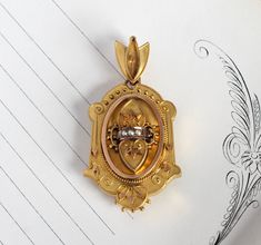 "A beautifully detailed antique Victorian locket circa 1875; crafted in 14k yellow gold featuring a romantic double heart design on the front cover, accented by delicate Etruscan-style filigree work and creamy white seed pearls. The back is plain and could be engraved with your choice of monogram initials, or perhaps a special date; with its deep inner chamber it's perfect for a photo or small keepsake such as a lock of hair. Please convo me before purchase if you are interested in the details o Victorian Heart Pendant Jewelry Collectible, Victorian Heart Pendant Collectible Jewelry, Victorian Yellow Gold Locket Jewelry, Victorian Heart Pendant Jewelry With Intricate Design, Victorian Heart Pendant With Intricate Design, Victorian Engraved Heart Pendant Jewelry, Victorian Yellow Gold Jewelry With Vintage Charm, Victorian Gold Heart Pendant Jewelry, Victorian Heart Pendant Jewelry For Formal Occasions