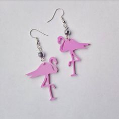 Pink Flamingo acrylic earrings A quirly kitsch style pair of earrings with a pink acrylic 3 cm Flamingos Hung from either a silver plated or sterling silver earring hook. Finished with a silver bead. Drop length: 1.5 inches All components are allergy and nickel free. Hand made in Britain. Pink Novelty Dangle Jewelry, Pink Novelty Earrings For Party, Fun Pink Dangle Jewelry, Pink Fun Dangle Jewelry, Whimsical Pink Nickel-free Earrings, Whimsical Nickel-free Pink Earrings, Quirky Handmade Pink Earrings, Summer Pink Pierced Jewelry, Quirky Pink Jewelry Gift