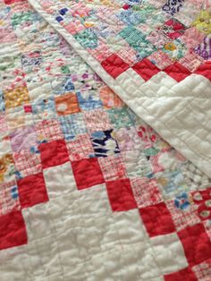 a quilt is laying on top of a bed