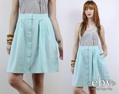 Vintage eighties HIGH WAISTED MINI SKIRT. Gorgeous SEAFOAM color. Buttons up front. Partial elastic waist. Hip pockets. Skirt has been cut shorter and professionally hemmed.  Model is 5'9. Her measurements are: bust=34 inches, waist=26 inches, & hips=34 inches. The skirt is too large for her, is clipped to show proper fit, and would be an ideal fit on a lady with a larger waist. A note from Savannah: I realize it looks ridiculous to have a large skirt being modeled by an XS model. Obviously, this is not ideal. We are constantly expanding our larger size inventory and are desperately trying to hire a larger lady to give a more accurate idea of fit. Thank you for your patience with our weird pictures in the meantime. We measure on a flat surface from seam to seam. Bust, waist, & hip measurem Seafoam Color, Elegant Style Women, Floral Babydoll Dress, Trendy Skirts, Skirt High Waist, Goth Dress, High Waist Skirt, Polka Dot Skirt, 90s Dress