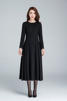 "This Long black dress design with midi length, match a black heel, make you more slim and high. This wool dress design with a smaller collar, so it open by back zipper, so that your head can through easily. This winter dress is warm in cold winter. it has a polyester lining, so don't need worry not comfortable. Details: * Made from black wool * 35% wool blend, 35% fiber and polyester, 30% nylon * Polyester lining * Big Round neckline * No pockets * Back zip closure * Long sleeve * Below the kne Elegant Long Sleeve Midi Dress For Winter, Black Pleated Long-sleeve Dress, Black Pleated Long Sleeve Dress, Long Winter Dress For Formal Occasions, Winter Pleated Long Sleeve Dress, Winter Pleated Long Sleeve Midi Dress, Winter Party Pleated Long Sleeve Dress, Winter Evening Midi Dress, Knee-length, Long Sleeve Pleated Midi Dress For Winter