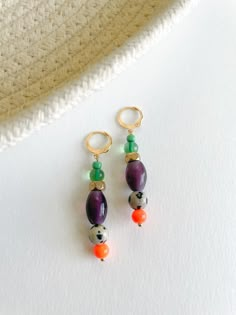 Add a burst of color to your collection with the Mecca Earrings. These vibrant earrings feature a delightful mix of various glass beads, lampwork beads, and brass accents, meticulously crafted to create a playful and unique accessory. Diverse Bead Composition: Each earring boasts a lively blend of various glass beads and lampwork beads, creating a colorful and dynamic design. Brass Accents: Delicate brass details add a touch of sophistication, enhancing the overall bohemian charm. Lever Back Earring Posts: Designed for comfort and security, ensuring a worry-free and enjoyable wear. Statement Length: These earrings measure 2 inches, making them a versatile and eye-catching addition to your jewelry collection. Materials: Various glass beads, lampwork beads, brass accents, lever back earring Bohemian Multicolor Czech Glass Earrings, Handmade Multicolor Glass Earrings, Multicolor Czech Glass Beaded Earrings For Pierced Ears, Multicolor Glass Beaded Earrings, Multicolor Glass Earrings With Colorful Beads, Multicolor Glass Bohemian Earrings, Multicolor Bohemian Glass Earrings, Bohemian Multicolor Glass Earrings, Multicolor Czech Glass Dangle Earrings