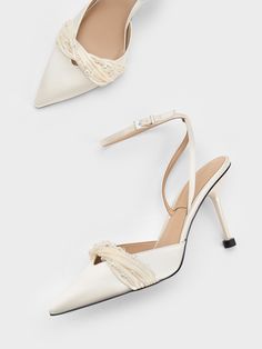 two pairs of white high heeled shoes