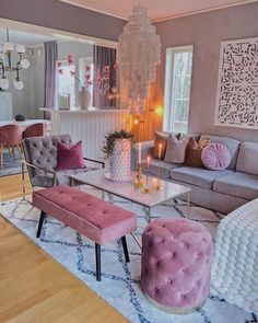 a living room filled with furniture and a chandelier