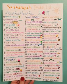 someone holding up a summer bucket list