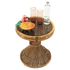 a wicker table topped with drinks and food