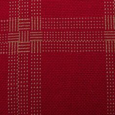 a red and white checkered fabric with small squares on it's side,