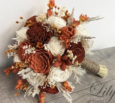 a bridal bouquet with white and brown flowers