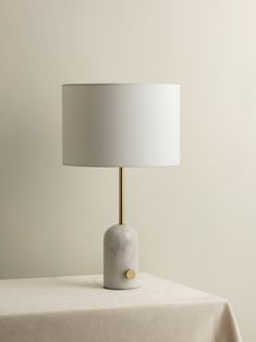 a white table with a lamp on it