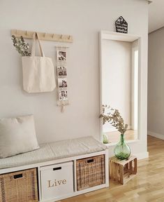 there is a bench with baskets on it in the living room next to an open door