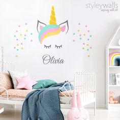 a child's bedroom with a unicorn wall decal