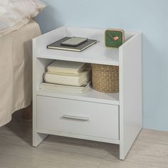 a nightstand with books and a phone on it