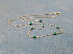 This dainty handmade necklace features 7 natural tiny Emerald gemstones wrapped on a chain. This delicate choker necklace is beautiful worn alone or layered with other necklaces. A classic and simple everyday piece that will make fashion look effortless. Customize yours by choosing your metal and length. This necklace design is also available in different gemstones. Makes a great gift to add to any gemstone lover's collection. Perfect to gift for Christmas, Valentine's Day, Mother's Day, and mor Dainty Wire Wrapped Round Bead Necklaces, Dainty Wire Wrapped Necklaces With Round Beads, Dainty Wire-wrapped Necklaces With Round Beads, Green Dainty Chain Necklace, Delicate Choker Necklace, Delicate Choker, Make Fashion, Emerald Bead, Necklace Design