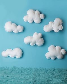 there are many clouds in the sky on this blue background and it looks like they have been made out of foam