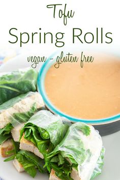 an image of spring rolls on a plate with dipping sauce and lettuce in the background