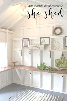 a white shed with shelves and pictures on the wall