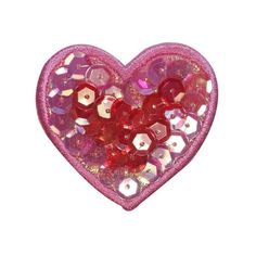 a pink heart shaped brooch with lots of beads