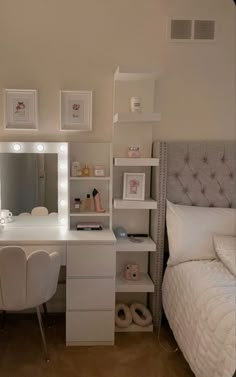 a bedroom with a bed, desk and mirror