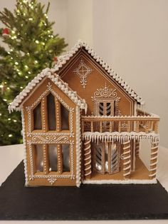 a gingerbread house is decorated with icing