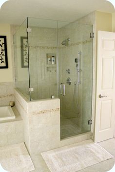 a bathroom with a walk in shower next to a bath tub