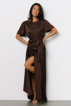 A beautiful + feminine style for any occasion Lovely solid brown Satin material with some stretch Rounded neckline Keyhole and button at back neck Short flutter sleeves Removable belt tie at natural waist Elastic back waist Left leg slit Maxi length skirt with gorgeous sweep Fully lined except for sleeves 100% Polyester Skye is 5'9, cup size 32A, size 0 and wearing size S Mei Li is 5’3, cup size 32A, size 0 and wearing size S Brown Satin Party Dress, Flattering Dresses For Curvy Women, Wedding Guest Outfit Fall, Wedding Colour, Baltic Born, Tulle Sleeves, Guest Attire