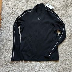 Nwt Nike Long Sleeve Mock Turtleneck Shirt. Slim Fit. Ribbed Material. Never Worn And In Great Shape. Size Women’s Xl. Black Shirt With White Piping Detail On Sleeves And Nike Logo On Front Top Center. Sporty White Turtleneck Top, Nike Fitted Winter Tops, Nike Stretch Winter Tops, Fitted Nike Tops For Winter, Winter Nike Stretch Tops, Nike Sporty Tops For Fall, Sporty Turtleneck Tops For Streetwear, Sporty Black Turtleneck Top, Winter Sporty Turtleneck Tops