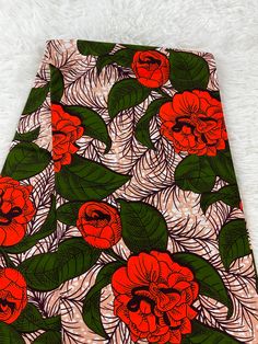 an orange and green floral print fabric on white fur