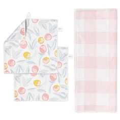 two pink and white towels next to each other on top of a checkered table cloth